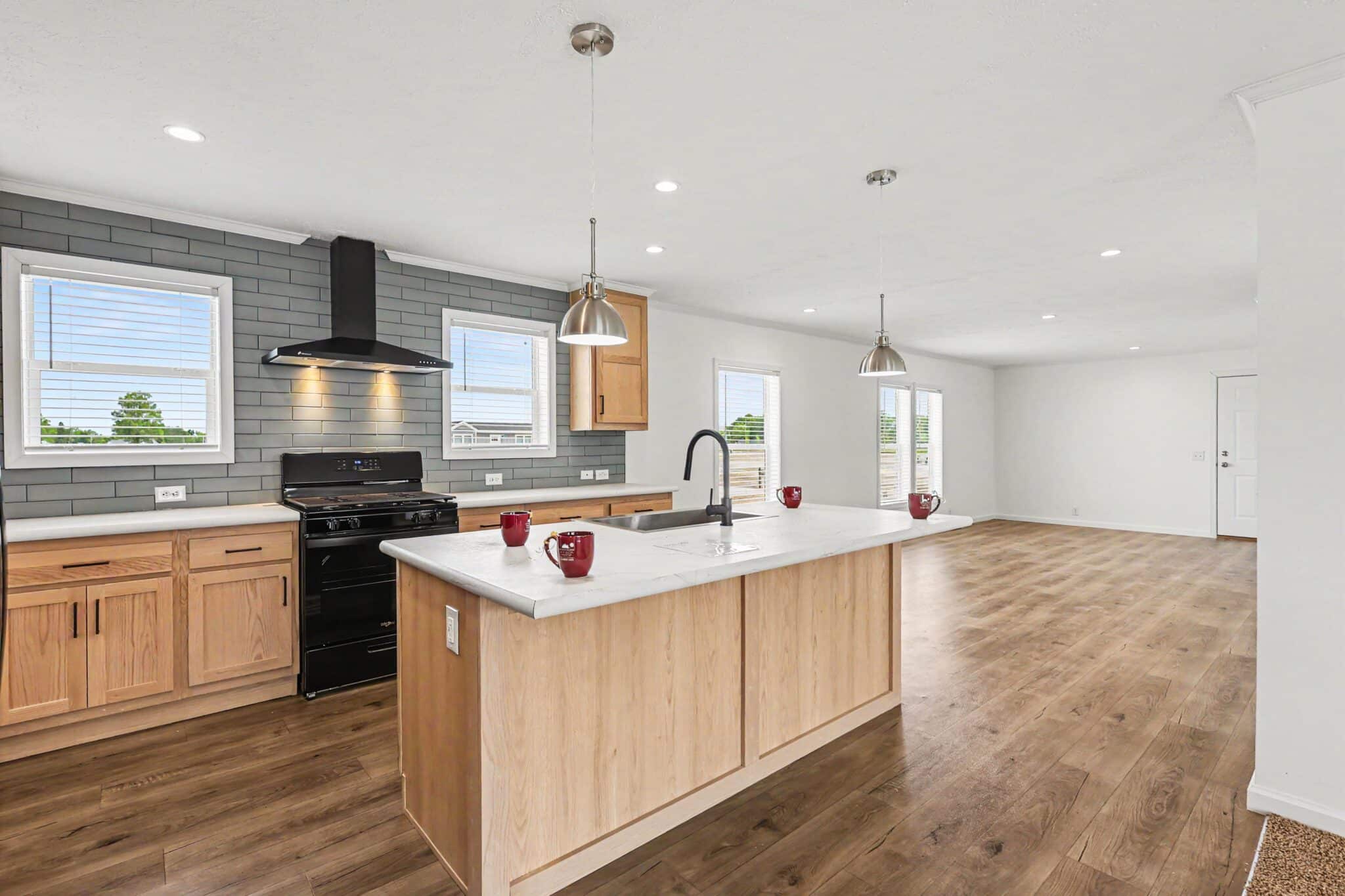 Oak kitchen with island and slate backsplash in a new manufactured home in Allendale, MI