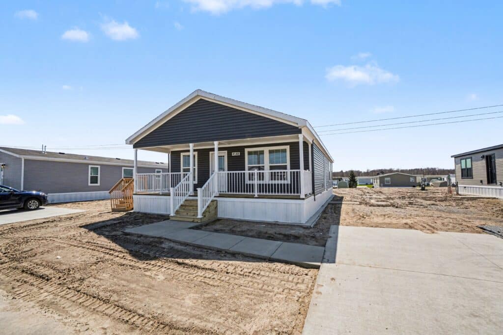 New navy manufactured home with covered porch for sale near Grand Rapids, MI