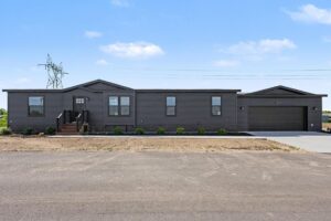 Front exterior of a new dark gray manufactured home with attached garage at 11856 Danton Circle in Allendale, MI
