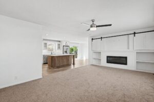 Living room with electric fireplace and built-in shelving in a new manufactured home at 11856 Danton Circle in Allendale, MI