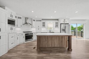 White kitchen with oak island and stainless appliances in a new manufactured home at 11856 Danton Circle in Allendale, MI