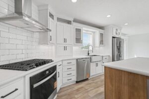 Kitchen with gas cooktop, range hood and subway tile in a new manufactured home at 11856 Danton Circle in Allendale, MI