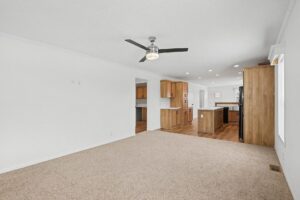 Open living room looking into the kitchen of a new manufactured home at 4140 Shalimar Dr in Allendale, MI