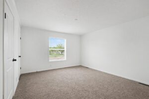 Carpeted bedroom with window in a new manufactured home at 4140 Shalimar Dr in Allendale, MI