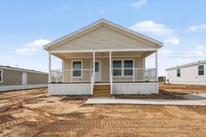 Covered front porch of a new manufactured home with cream siding at 4152 Shalimar Dr in Allendale, MI