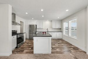Kitchen with stainless range, hood and white shaker cabinets in a new manufactured home at 4152 Shalimar Dr in Allendale, MI