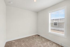 Carpeted bedroom with large window in a new manufactured home at 4152 Shalimar Dr in Allendale, MI