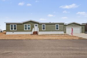 Front exterior of a new green manufactured home with attached garage at 4159 Shalimar Dr in Allendale, MI