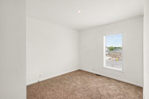 Carpeted bedroom with window in a new manufactured home at 4159 Shalimar Dr in Allendale, MI