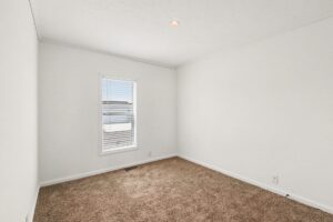 Carpeted bedroom with window in a new manufactured home at 4159 Shalimar Dr in Allendale, MI