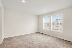 Carpeted bedroom with two windows in a new manufactured home at 4160 Shalimar Dr in Allendale, MI
