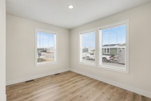 Bedroom with two windows and wood-look flooring in a new manufactured home at 4160 Shalimar Dr in Allendale, MI