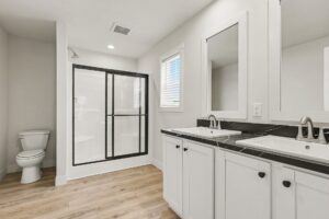 Bathroom with double vanity and glass shower in a new manufactured home at 4160 Shalimar Dr in Allendale, MI