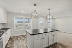 Kitchen island with pendant lights and windows in a new manufactured home at 4180 Shalimar Dr in Allendale, MI