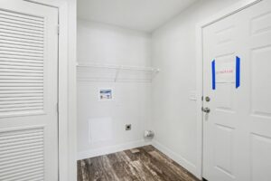 Laundry room with louvered doors in a new manufactured home at 4180 Shalimar Dr in Allendale, MI