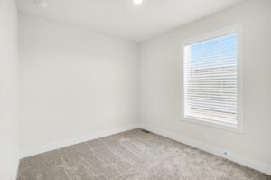 Carpeted bedroom with window in a new manufactured home at 4180 Shalimar Dr in Allendale, MI