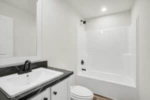 Bathroom with tub and shower combination in a new manufactured home at 4180 Shalimar Dr in Allendale, MI