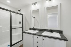 Bathroom with double vanity and glass shower in a new manufactured home at 4180 Shalimar Dr in Allendale, MI