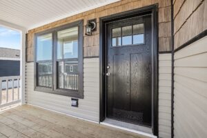 Covered front porch with black front door on a new manufactured home at 4188 Shalimar Dr in Allendale, MI