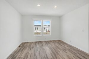 Bedroom with wood-look flooring and window in a new manufactured home at 4188 Shalimar Dr in Allendale, MI