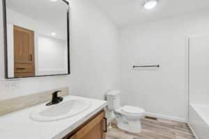 Bathroom with oak vanity and tub in a new manufactured home at 4188 Shalimar Dr in Allendale, MI