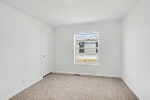 Carpeted bedroom with window in a new manufactured home at 4188 Shalimar Dr in Allendale, MI