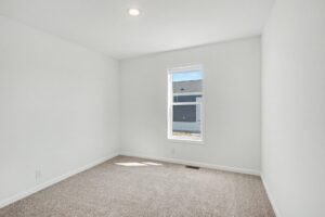 Carpeted bedroom with window in a new manufactured home at 4188 Shalimar Dr in Allendale, MI