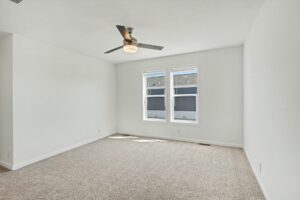 Carpeted primary bedroom with ceiling fan in a new manufactured home at 4188 Shalimar Dr in Allendale, MI