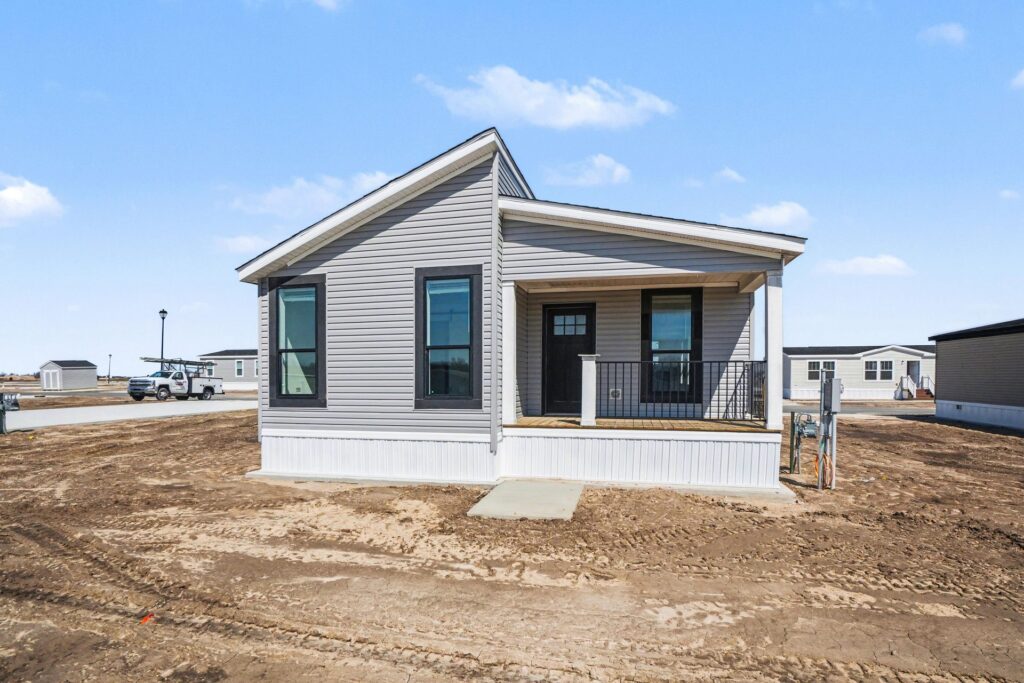 Front exterior of a new gray manufactured home with covered porch at 4198 Shalimar Dr in Allendale, MI