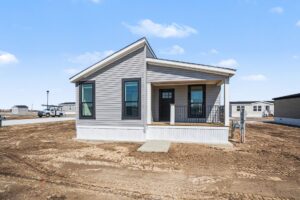 Front exterior of a new gray manufactured home with covered porch at 4198 Shalimar Dr in Allendale, MI