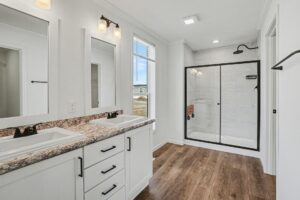 Bathroom with granite-look vanity and glass shower in a new manufactured home at 4198 Shalimar Dr in Allendale, MI