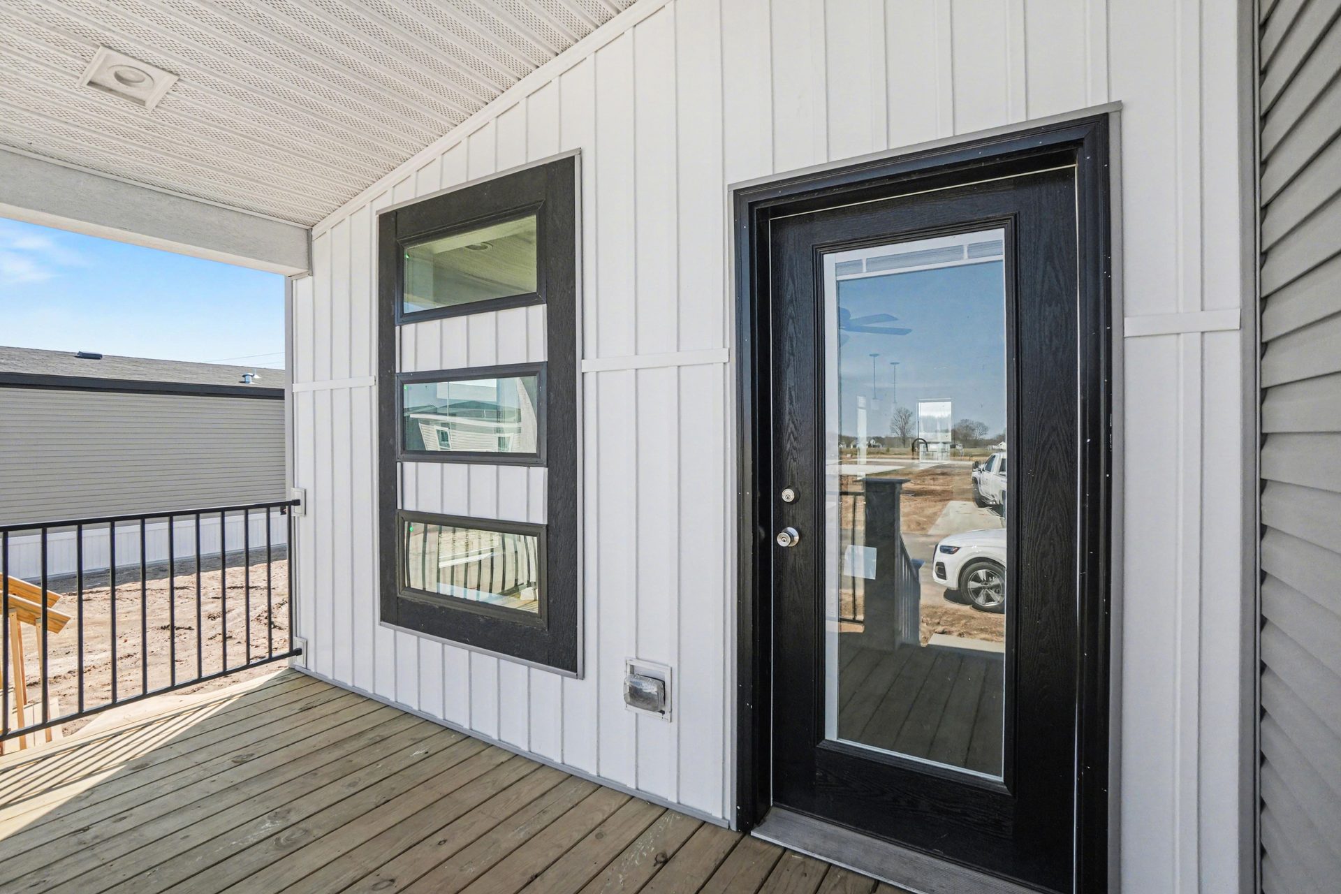 Covered porch and black front door on a new manufactured home at 4198 Shalimar Dr in Allendale, MI