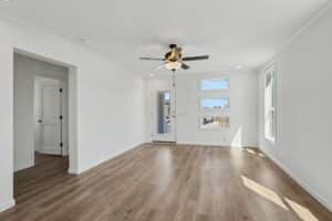 Living room with ceiling fan and wood-look flooring in a new manufactured home at 4198 Shalimar Dr in Allendale, MI