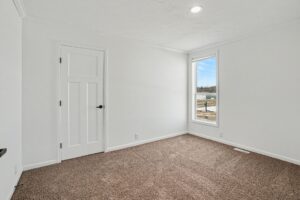Carpeted bedroom with window in a new manufactured home at 4198 Shalimar Dr in Allendale, MI