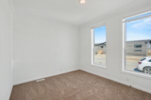 Carpeted bedroom with corner windows in a new manufactured home at 4198 Shalimar Dr in Allendale, MI