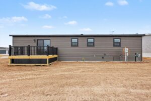Rear deck and exterior of a new brown manufactured home at 4201 Shalimar Dr in Allendale, MI