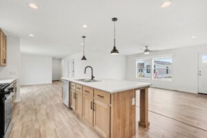Kitchen with oak island and pendant lights in a new manufactured home at 4201 Shalimar Dr in Allendale, MI