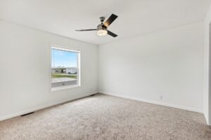 Carpeted bedroom with ceiling fan in a new manufactured home at 4201 Shalimar Dr in Allendale, MI