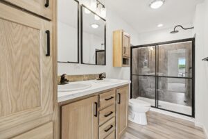 Bathroom with oak vanity and tile shower in a new manufactured home at 4201 Shalimar Dr in Allendale, MI
