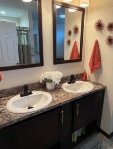 Bathroom with double vanity in a pre-owned manufactured home at 4393 Twilight Way in Allendale, MI