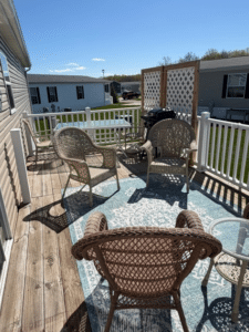 Deck with patio furniture at a pre-owned manufactured home at 4393 Twilight Way in Allendale, MI