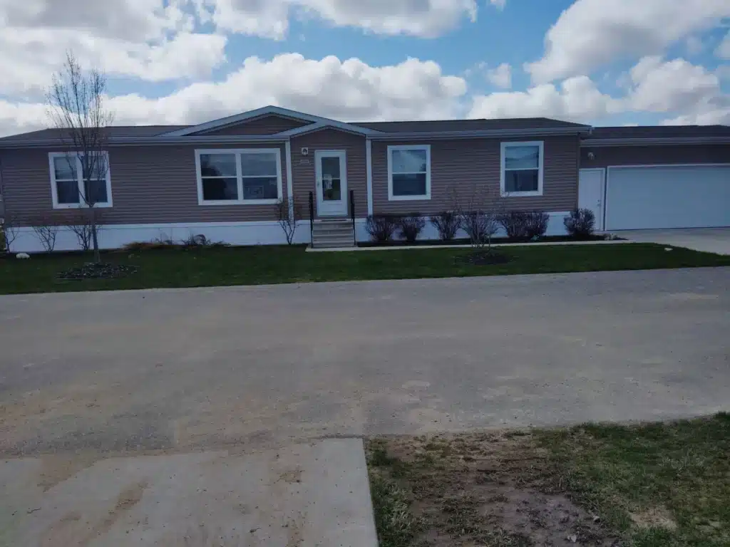 Street view of a pre-owned manufactured home with driveway at 4393 Twilight Way in Allendale, MI