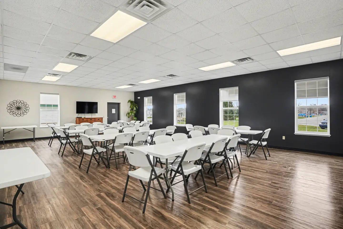 Clubhouse event room with tables set for residents at the manufactured home community in Allendale, MI