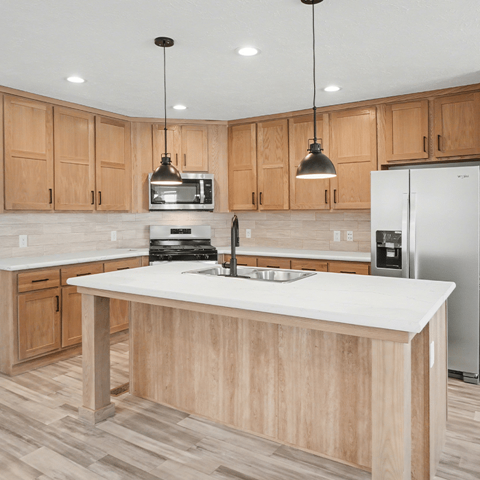 Custom oak kitchen with island in a manufactured home built to order near Grand Haven, MI
