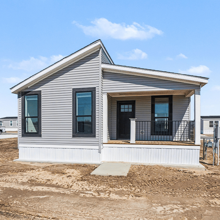 New gray manufactured home with covered porch ready for sale in Allendale, MI