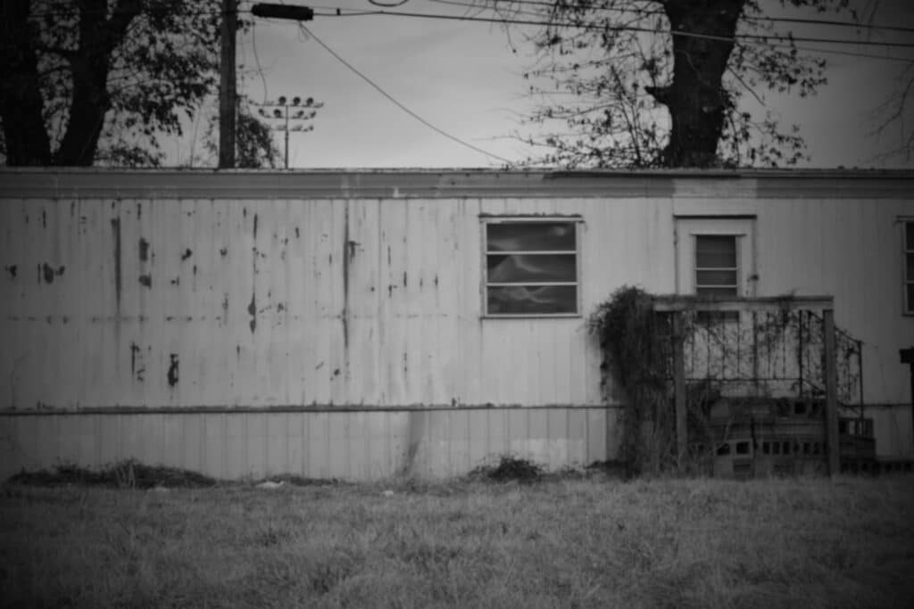Black and white photo of an early trailer home in Allendale, MI