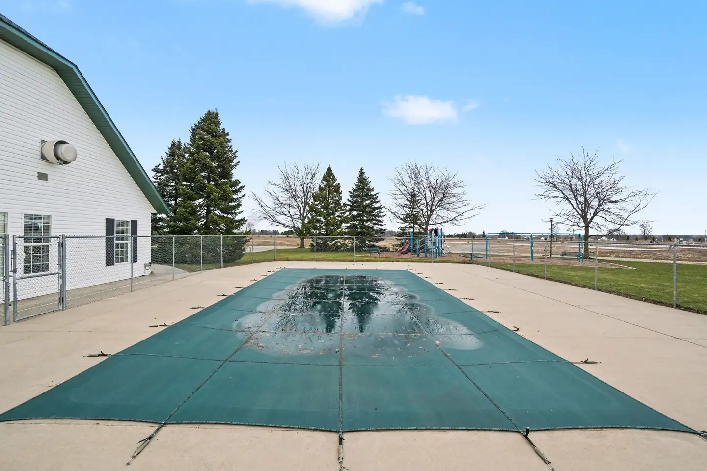 Outdoor swimming pool beside the clubhouse at the manufactured home community in Allendale, MI