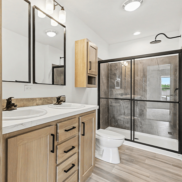 Bathroom with oak vanity and tile shower in a quality manufactured home in Allendale, MI
