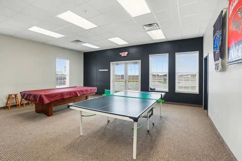Game room with ping-pong and pool tables in the clubhouse