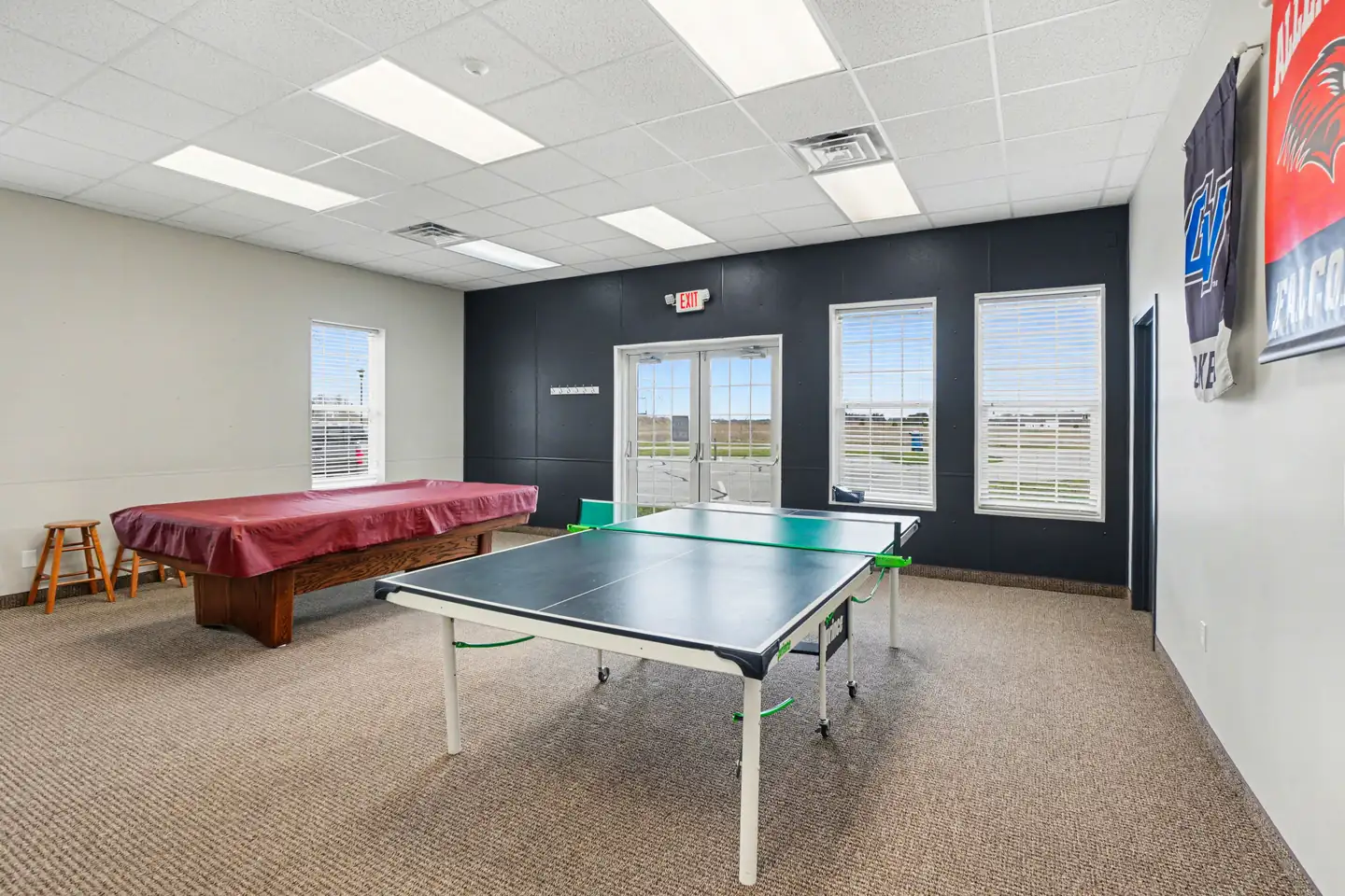 Game room with ping-pong and pool tables in the clubhouse in Allendale, MI